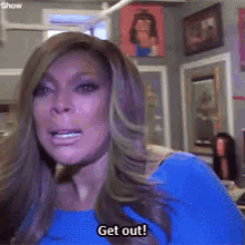 a woman in a blue shirt says get out