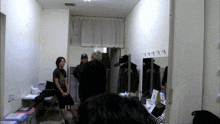 a man in a black t-shirt that says ' nirvana ' on it sits in a locker room