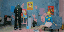a man in a dinosaur costume stands next to a woman in a polka dot skirt