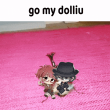a picture of two dolls on a pink rug with the words go my dolliu