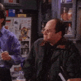 two men are standing in front of a refrigerator with a sticker that says gw on it