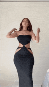 a woman in a black strapless dress is dancing