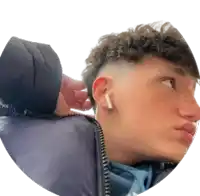 a person is touching a young man 's ear with a pair of airpods