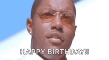 a man wearing sunglasses is giving a happy birthday speech .