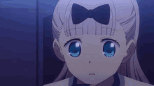 a close up of a girl with a bow on her hair