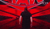 a man in a black shirt is walking down a red aisle .