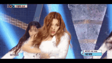 a girl with red hair is dancing on a stage with a sign that says # 0505
