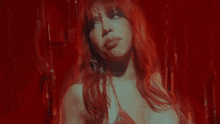 a woman with red hair is making a funny face