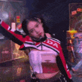 a woman in a red and black honda jacket is dancing in a room .