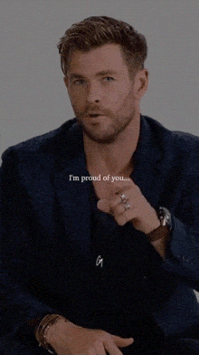 a man in a suit says " i 'm proud of you " while pointing at the camera