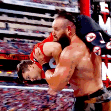 a man is carrying another man on his back in a wrestling match