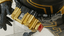 a person wearing a black and gold costume has a belt with the number 07 on it