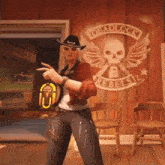 a woman in a cowboy hat is standing in front of a wall with a skull and wings painted on it .