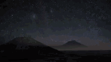 two large telescopes under a starry night sky with a milky way in the background