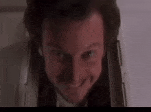 a close up of a man 's face looking out of a box