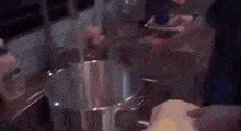 a person is cooking in a pot in a kitchen .
