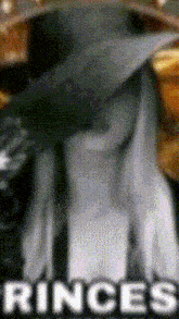 a close up of a person wearing a graduation cap and gown with the words rinces in white letters