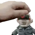 a hand is touching a stuffed toy with a red heart on it .