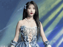 a woman in a blue and white dress with chinese writing on the bottom