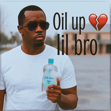 a man is holding a bottle of johnson 's baby oil in his hand