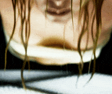 a close up of a person 's face with a blurred background