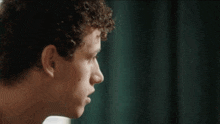 a close up of a man 's face looking out a window .