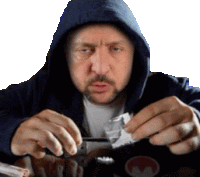 a man in a blue hoodie is holding a bag of cocaine in his hands