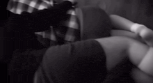 a man in a plaid shirt is laying on a couch