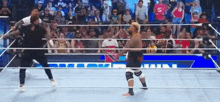 a man is standing in a wrestling ring with a crowd watching .
