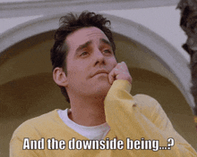 a man in a yellow sweater says " and the downside being .... "