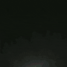 a black and orange circle with a bunch of triangles inside of it
