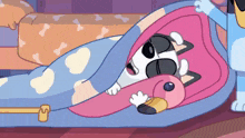 a cartoon dog is laying under a pink blanket .