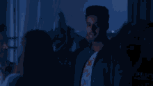 a woman in a red jacket is looking up at the lights