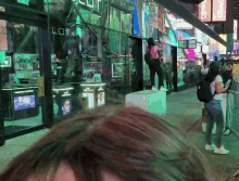 a woman stands in front of a store that has the word lot on it