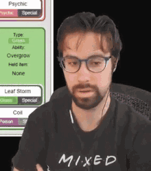 a man with glasses and a beard is wearing a black shirt that says mixed