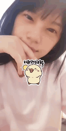 a girl with a sticker of a chicken on her face that says morning
