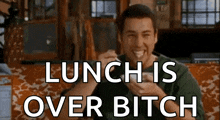 a man is sitting on a couch with a spoon in his mouth and the words lunch is over bitch below him