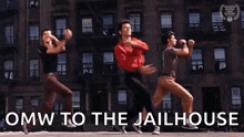 a group of young men are dancing in front of a building .