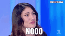 a woman is crying and the word nooo is on her face
