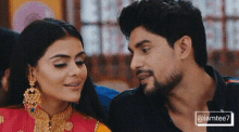a man and a woman are looking into each other 's eyes .