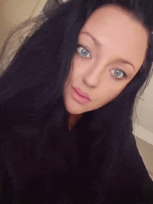 a close up of a woman with blue eyes