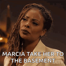 a woman says marcia take her to the basement on a screen