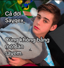 a young man is laying on a bed with the words saygex written above him