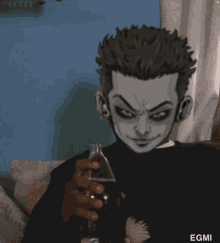 a man is sitting on a couch holding a bottle of soda with the name egmi on the bottom of the image