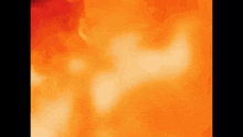 a close up of a red and orange background with a smoke coming out of it