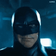 a close up of a man in a batman mask
