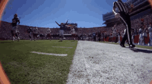 a football game is being played in a stadium and a referee is walking down the field