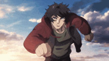 a man in a red jacket is running with his fist up in the air