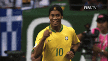 a soccer player wearing a yellow jersey with the number 10
