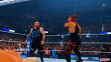 a group of wrestlers are in a ring holding signs that say rko
